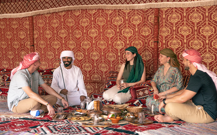 Private dining setup by a desert oasis under a glowing canopy.