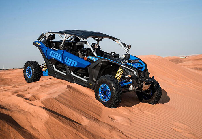 Can-Am Maverick X3 parked on desert dunes, ready for an adventure.