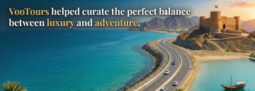 VooTours luxury chauffeur car on Fujairah coastal road with mountains and sea view